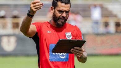 El entrenador venezolano Daniel Blanco, asistente técnico de la Selección de Panamá, de pie en un campo de entrenamiento con camiseta roja de la FEPAFUT, sosteniendo una tableta digital y un lápiz óptico mientras imparte instrucciones tácticas.